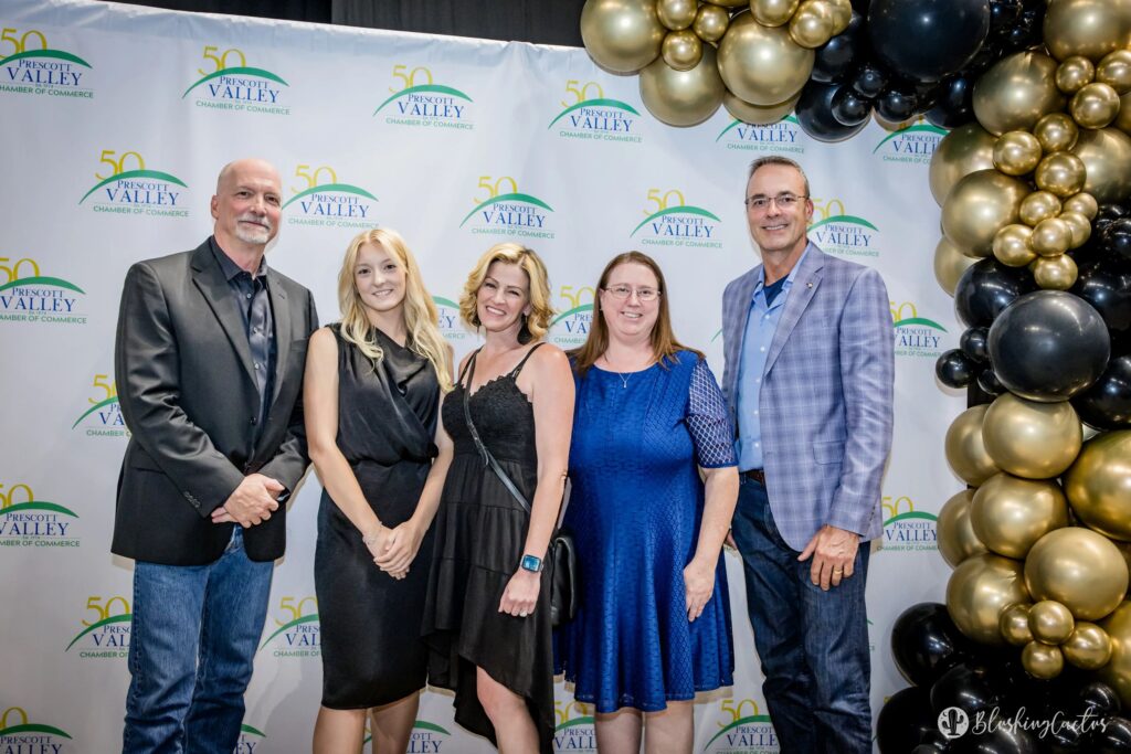 Talking Glass media team standing in front of a Prescott Valley Chamber backdrop at the gala.