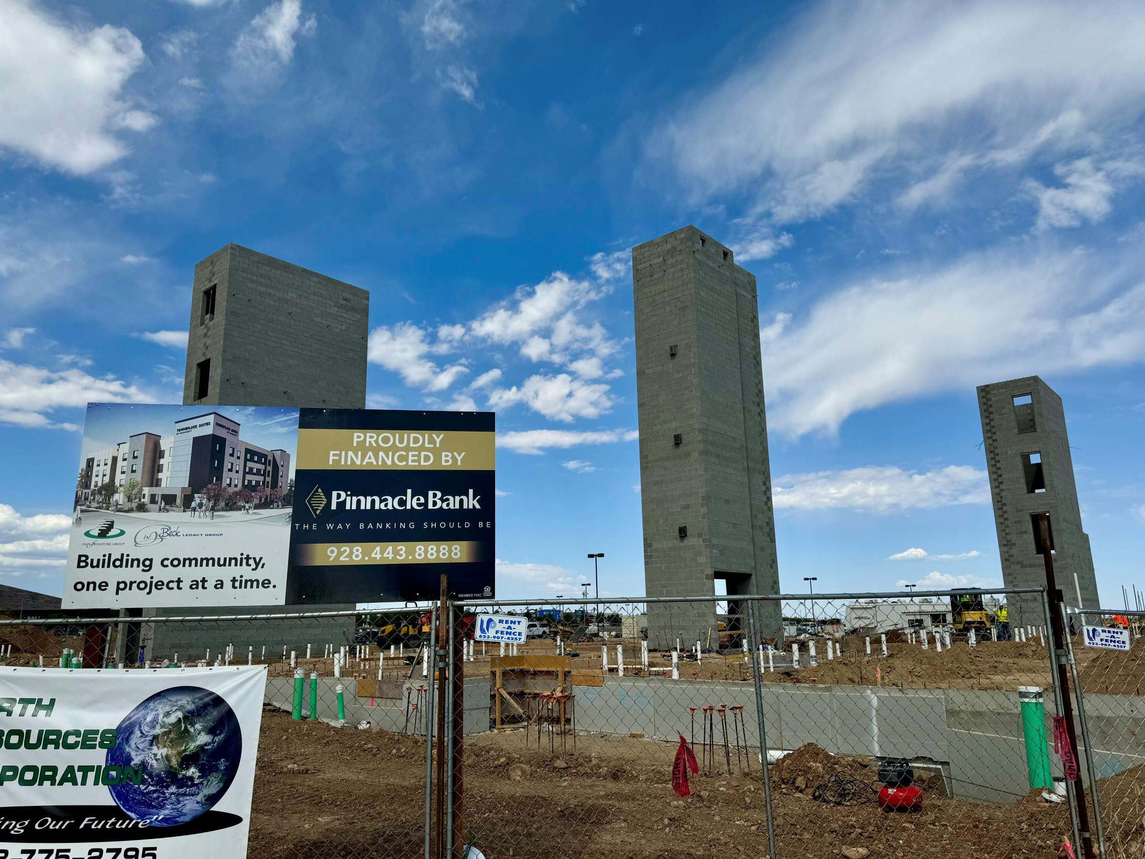 The towers of the new Marriot structure stand tall among the blue sky.