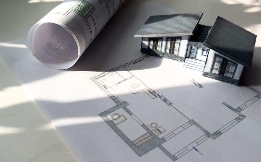 model house with blueprints