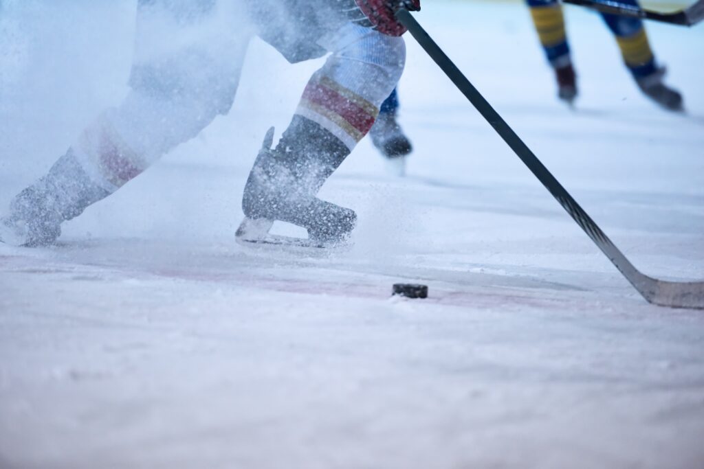 ice hockey player in action kicking with stick