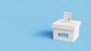 Vote into a ballot box during elections